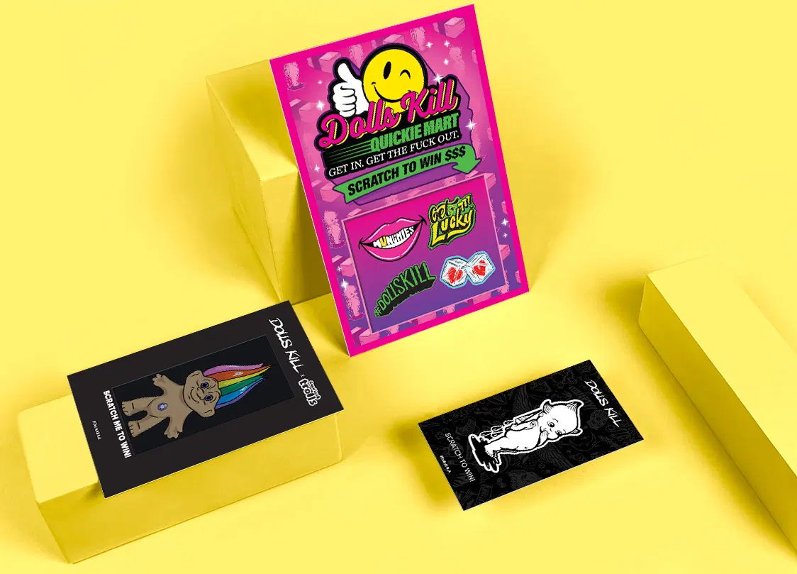 Dolls Kill full-color scratch off promo card for an online fashion drop