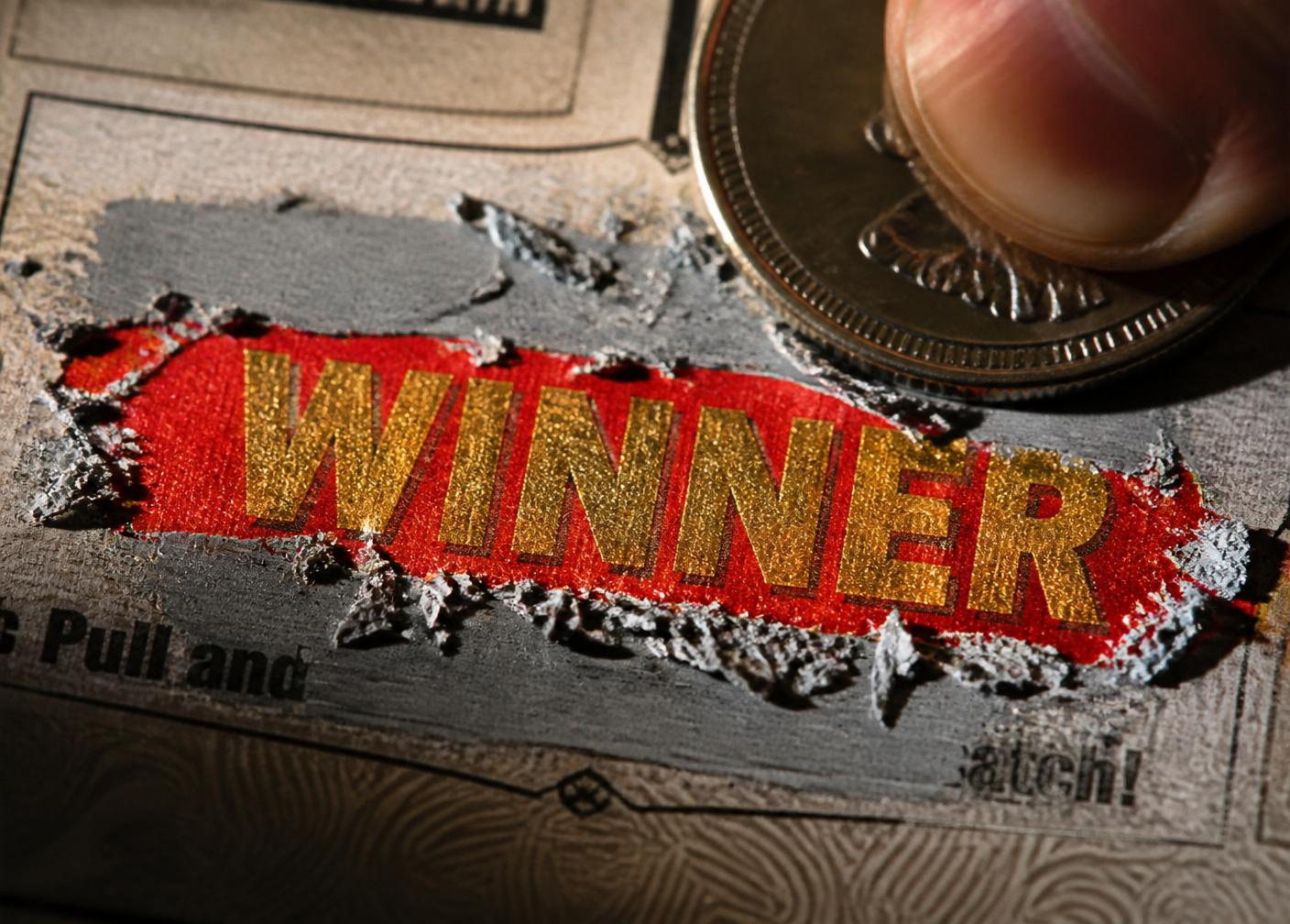 Macro close-up of scratch-off latex being removed to reveal a prize code
